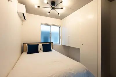 a bedroom with a bed with a ceiling fan at Luxe\u5357\u9752\u5c71 in Tokyo