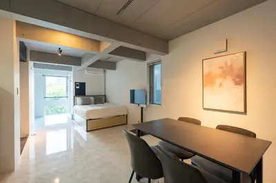 a room with a table and chairs and a bed at Luxe\u5357\u9752\u5c71 in Tokyo