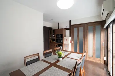 a kitchen and dining room with a table and chairs at Apro Stay \u7530\u5712\u8abf\u5e03\u591a\u6469\u5ddd in Tokyo