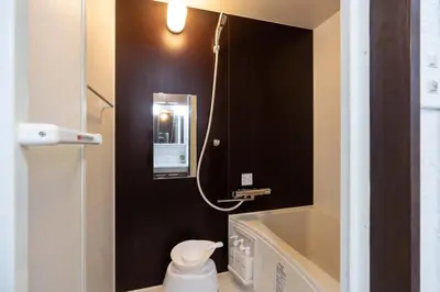 a bathroom with a toilet and a sink and a bath tub at Apro Stay \u7530\u5712\u8abf\u5e03\u591a\u6469\u5ddd in Tokyo