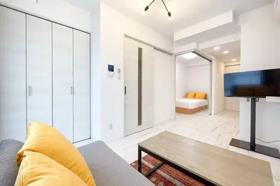 a living room with a couch and a table at \u30bf\u30b9\u30adsmart\u6771\u65b0\u5bbf in Tokyo