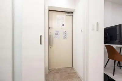 a door leading into a room with a table at \u30bf\u30b9\u30adsmart\u6771\u65b0\u5bbf in Tokyo