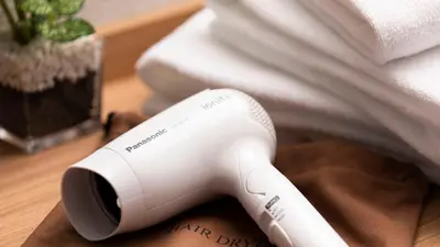 a white hair dryer sitting on top of a table at HOTEL MYSTAYS Higashi Jujo in Tokyo