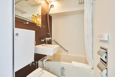 a bathroom with a sink and a toilet at HOTEL MYSTAYS Higashi Jujo in Tokyo