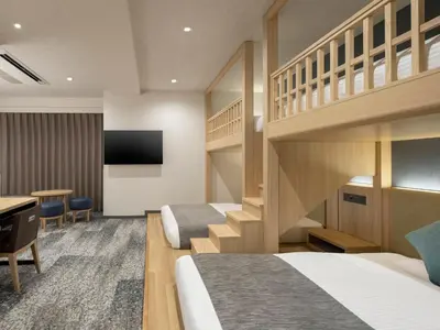 a hotel room with two bunk beds and a desk at HOTEL MYSTAYS Iidabashi in Tokyo