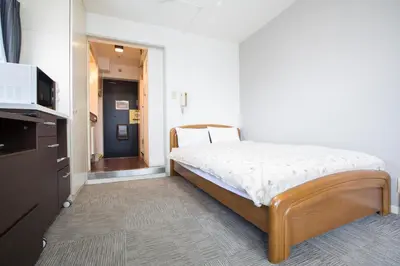 a small bedroom with a bed in a room at FLEXSTAY INN Nakanobu in Tokyo
