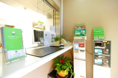a pharmacyacist with a counter with a cash register at FLEXSTAY INN Nakanobu in Tokyo