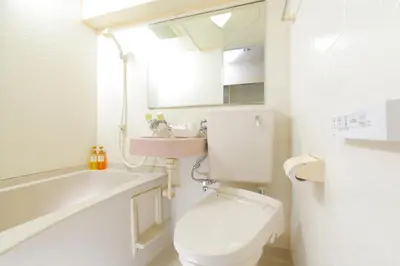 a white bathroom with a toilet and a sink at FLEXSTAY INN Shinurayasu in Urayasu