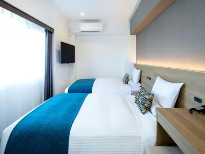 a hotel room with two beds and a window at FLEXSTAY INN Shinurayasu in Urayasu