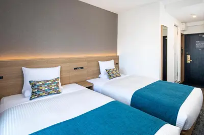 two beds in a hotel room with two at FLEXSTAY INN Shinurayasu in Urayasu