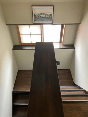 an attic room with a staircase and a window at Lodging Tokyo Shibamata in Tokyo