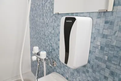 a toilet paper dispenser on the wall of a bathroom at Lodging Tokyo Shibamata in Tokyo