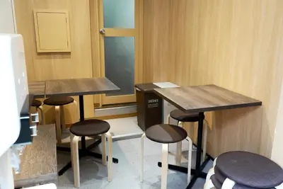 a row of tables and stools in a room at Lodging Tokyo Shibamata in Tokyo