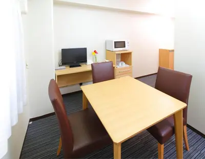 a conference room with a wooden table and chairs at FLEXSTAY INN Tokiwadai in Tokyo