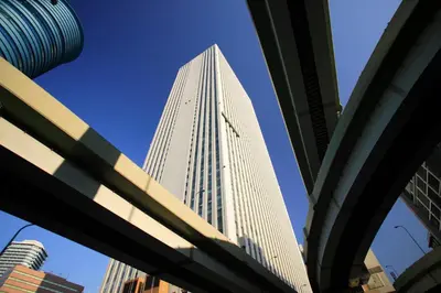 a tall white building with a blue sky in the background at FLEXSTAY INN Tokiwadai in Tokyo