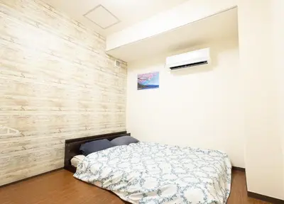 a bedroom with a bed and a wooden wall at Comptoir Shinjuku - Vacation STAY 15325 in Tokyo