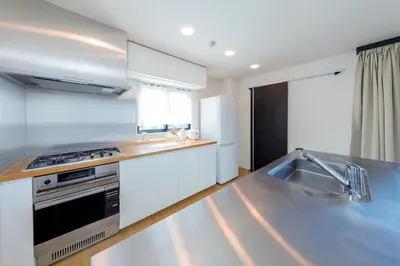 a kitchen with a sink and a stove top oven at Kiyosumi SOHO by Tranova in Tokyo