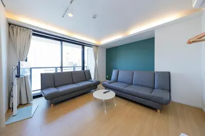 a living room with a couch and a table at Kiyosumi SOHO by Tranova in Tokyo