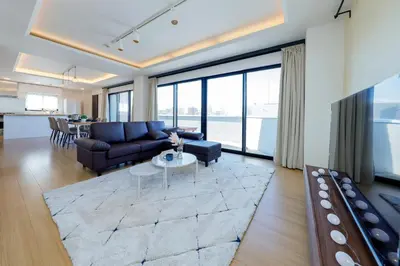 a living room with a couch and a table at Kiyosumi SOHO by Tranova in Tokyo