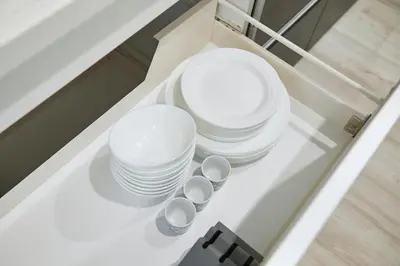 a group of white plates and spoons on a table at Shinjuku 'Orange County' Villa in Tokyo