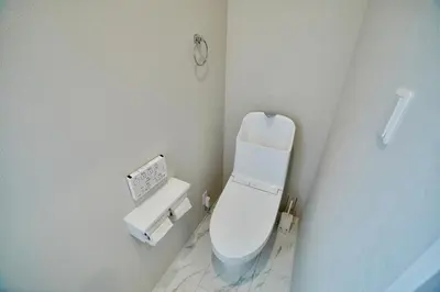 a white bathroom with a toilet and a sink at Shinjuku 'Orange County' Villa in Tokyo