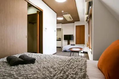 a bedroom with a large bed with two pillows on it at J-Court Oshiage in Tokyo