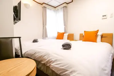 two beds sitting next to each other in a room at J-Court Oshiage in Tokyo