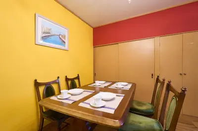 a dining room with a wooden table and chairs at Total 107square meter 4min to nearest staion Max16pp in Tokyo