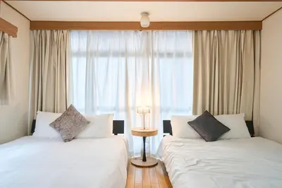 a hotel room with two beds and a window at Total 107square meter 4min to nearest staion Max16pp in Tokyo