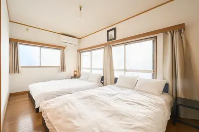 two beds in a room with two windows at Total 107square meter 4min to nearest staion Max16pp in Tokyo