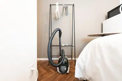 a vacuum on the floor in a room at Verde\u6c60\u888b in Tokyo