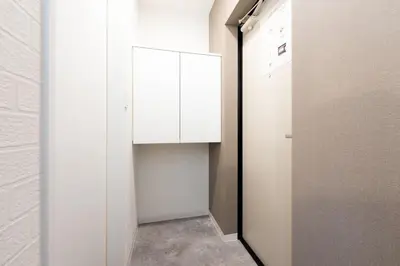 a small closet with white cabinets in a room at Verde\u6c60\u888b in Tokyo