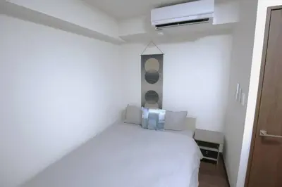 a white bedroom with a bed and a air conditioner at NEW OPEN 4BR, 110\u33a1 Walk to Asakusa in Tokyo