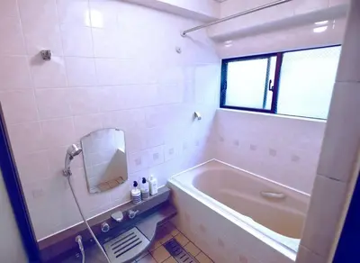 a bathroom with a bath tub and a mirror at NEW OPEN 4BR, 110\u33a1 Walk to Asakusa in Tokyo