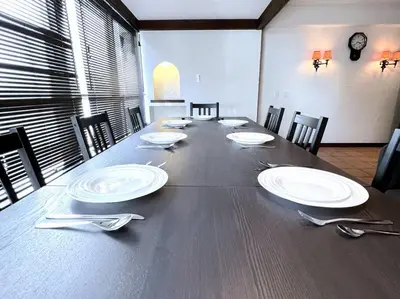 a large wooden table with plates and silverware on it at NEW OPEN 4BR, 110\u33a1 Walk to Asakusa in Tokyo