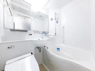 a white bathroom with a tub and a sink at APA Hotel Higashi Nihombashi Ekimae in Tokyo