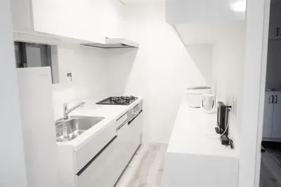 a white kitchen with a sink and a stove at Private Hotel Season Spring in Tokyo