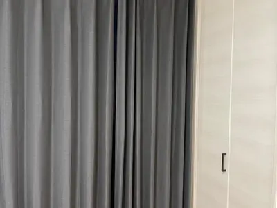 a gray curtain in front of a window at Private Hotel Season Spring in Tokyo