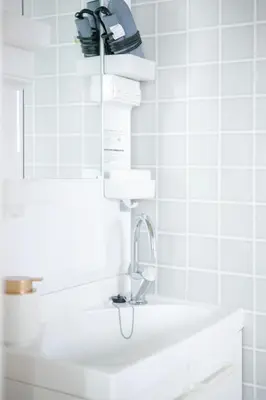 a white bathroom with a sink and a faucet at Pufuka Kanegafuchi \u3077\u3075\u304b\u9418\u30f6\u6df5 in Tokyo