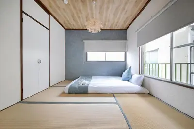 a bedroom with a bed and a large window at Pufuka Kanegafuchi \u3077\u3075\u304b\u9418\u30f6\u6df5 in Tokyo