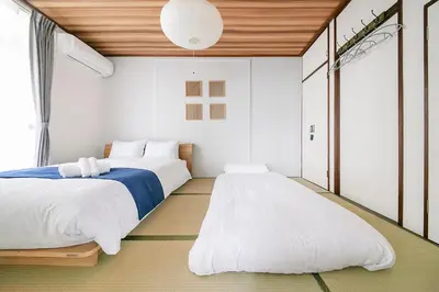 a bedroom with two beds and a large window at Pufuka Kanegafuchi \u3077\u3075\u304b\u9418\u30f6\u6df5 in Tokyo