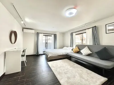 a living room with a couch and a bed in it at Sugamo-4F-TS0337 in Tokyo