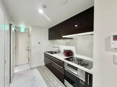 a kitchen with black and white cabinets and a sink at Sugamo-4F-TS0337 in Tokyo