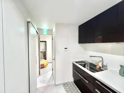 a kitchen with white walls and black cabinets and a sink at Sugamo-4F-TS0337 in Tokyo