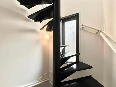 a black staircase with a mirror on the wall at Sugamo-4F-TS0337 in Tokyo
