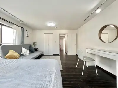 a bedroom with a bed and a desk and a mirror at Sugamo-4F-TS0337 in Tokyo