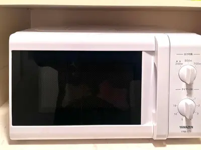 a white microwave oven with its door open at Ikebukuro Sugamo 202 in Tokyo