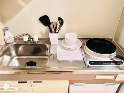 a kitchen counter with a sink and a stove at Ikebukuro Sugamo 202 in Tokyo