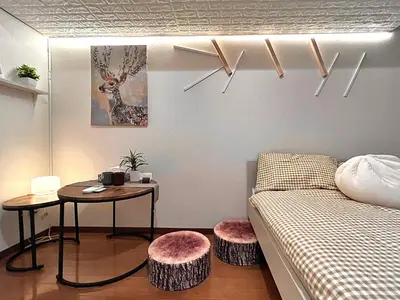 a bedroom with a bed and a table with two stools at Ikebukuro Sugamo 202 in Tokyo