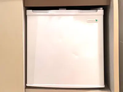 a white refrigerator freezer sitting in a kitchen at Ikebukuro Sugamo 202 in Tokyo